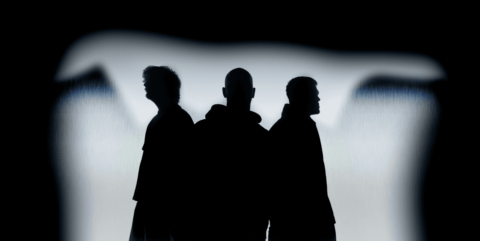 The three members of MINIMA in silhouette against a bright backdrop